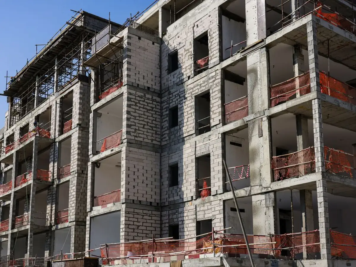 A multi-story residential development under construction with scaffolding